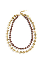 Gekoppelde ketting met gouden en gekleurde kralen